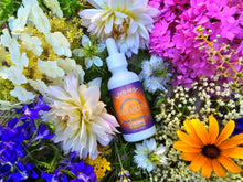 Load image into Gallery viewer, Dreamland 2100MG CBD oil among colorful flowers