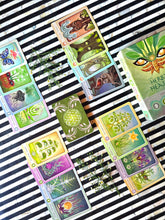 Load image into Gallery viewer, The Herbal Healing Deck illustrated plant cards arranged with fresh botanicals